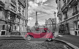 Eiffel Tower in Paris and red retro car in black and white color-key