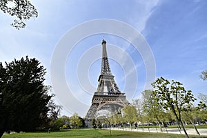 The Eiffel Tower in Paris. View from Champ de Mars park area in a very beautiful sunny day.