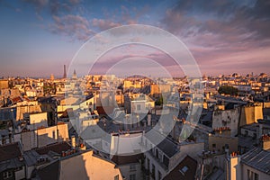 Eiffel tower and parisian roofs at sunrise Paris, France