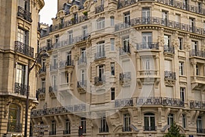 Eiffel tower between Parisian tenement old street alley and buildings