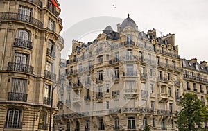 Eiffel tower between Parisian tenement old street alley and buildings