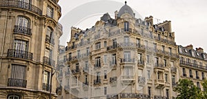 Eiffel tower between Parisian tenement old street alley and buildings