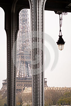 The Eiffel Tower between the pillars of the Bir Hakeim bridge in Paris on a cloudy cold winter day