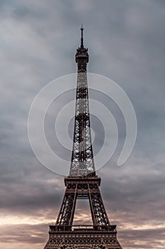 The Eiffel tower raising to the cloudy sky in Paris