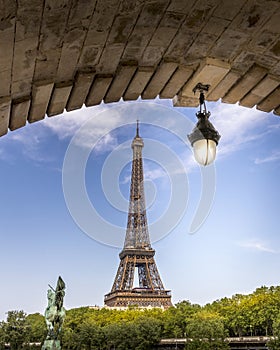 Eiffel tower seen from arch of Bir Hakeim bridge in Paris