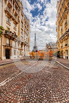 Eiffel Tower seen from the street in Paris, France. Cobblestone pavement photo