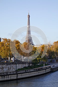 Eiffel tower and Seine river with autumn trees in a sunny day in Paris, France