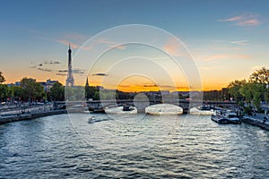 Eiffel Tower by the Seine River in Paris at sunset, France