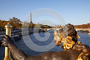 Eiffel tower and Seine river seen in a sunny day from Alexander III bridge in Paris, statue detail
