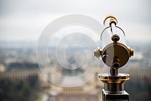 Eiffel Tower telescope overlooking for Paris. Old panoramic viewer or telescope on the Eiffel tower top.