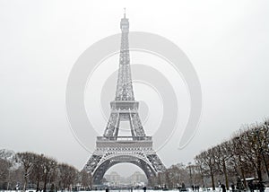 The eiffel tower under falling snow