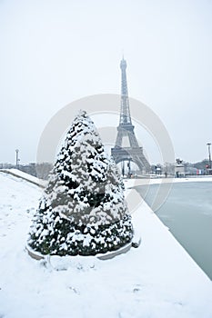 Eiffel tower under the snow in winter in Paris