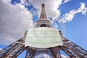 Eiffel tower wearing a surgical mask. New coronavirus, covid-19 in Paris France epidemic concept