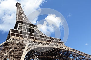 Eiffel tower wide low angle view looking upwards into blue sky, copy space