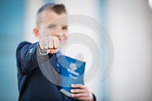 Eight (8) Year Old Boy Holding a Book of Mormon with HIs Fist Closed showing CTR Power Ring