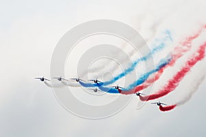 Eight aircraft at the air show demonstrate aerobatics figures