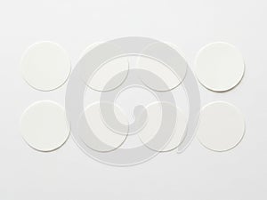 Eight circular white objects arranged in two rows isolated on white background