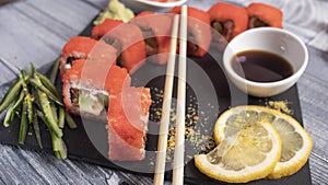 Eight pieces of rolls with caviar, lemon, sticks, cucumber, soy photo