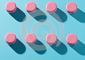 Eight pink caps arranged in two rows on a blue background