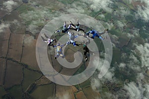 Eight skydivers building a formation