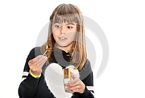 Eight year old girl playing with matches isolated on white