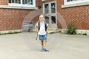 Eight years old school girl close to the schoolyards