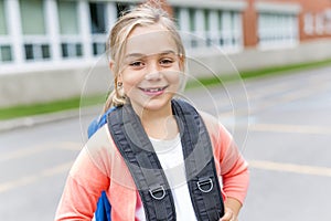 Eight years old school girl close to the schoolyards