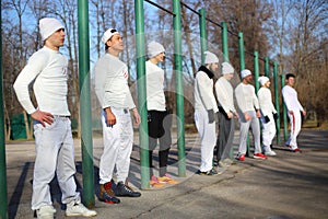 Eight young men near the long horizontal bar at photo