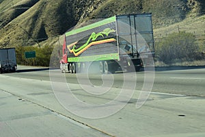 Eighteen wheeler semi truck driving down a mountain