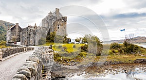 Eilean Donan castle panorama with Scottish flag