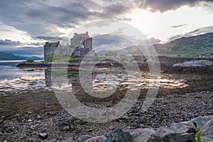 Eilean Donan Castle during sunset while canoes passing by - Dornie, Scotland