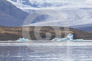 Eisberg in lagoon with glacier background, Iceland photo