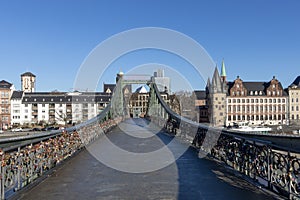 Eiserner Steg, famous iron footbridge crosses river Main in Frankfurt with skyline i