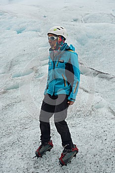 A mountain guide helps ice trekking tourists on Perito Moreno Glacier in the Los Glaciares National Park