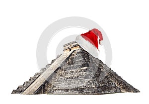 El Castillo, also known as the Temple of Kukulcan with Santa Claus hat isolated on white background.