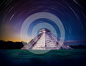 El Castillo pyramid in Chichen Itza, Yucatan, Mexico, at night with star trails
