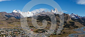 El Chalten village with panorama of mountain range Fitz Roy on a sunny day with blue sky. It is a mountain in Patagonia