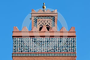 The El Mansour Mosque minaret against a blue sky, Marrakesh