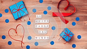 El mejor papa del mundo words that mean best dad in the world made of wooden blocks with blue gift boxes and red hearts on wooden photo