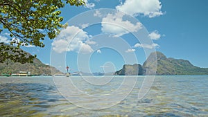 El Nido coastline. Palawan, Philippines. Bangka banca boats floating in shallow blue water lagoon