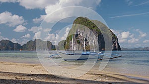 El Nido. Filippino boat on shore with Pinagbuyutan island in background. Palawan, Bacuit archipelago, Philippines