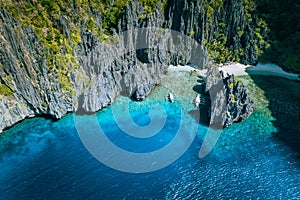 El Nido, Palawan, Philippines. Aerial above view of banca boats surrounded by karst scenery rocks at Secret Lagoon beach