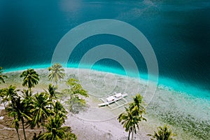 El Nido, Palawan, Philippines. Aerial drone view of tourist island hopping boats moored at tropical Ipil beach on photo