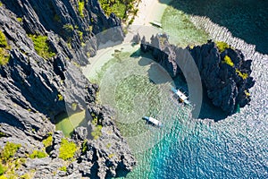 El Nido, Palawan, Philippines, aerial view of boats and cliffs rocky mountains scenery at Secret Lagoon beach