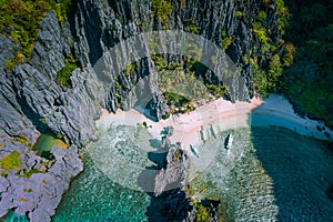 El Nido, Palawan, Philippines. Aerial view of Secret hidden lagoon beach with tourist banca boats on island hopping tour