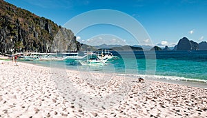 Tourist boats perched on the beautiful white sand beach, El Nido, Philippines.