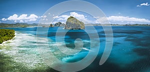 El Nido, Palawan, Philippines. Panoramic aerial view lonely tourist boat in open sea with exotic tropical Pinagbuyutan