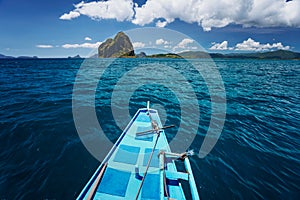 El Nido, Palawan, Philippines. Traditional banca boat on the way to amazing Pinagbuyatan Island. A small circular island