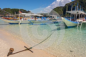 El Nido Palawan Philippines: Tropical landscape with boat, blue and crystal clear sea water, white sand and island