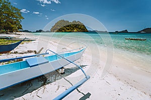 El Nido, Palawan, Philippines. White banca boat at Las cabanas beach with tropical island in background. Beautiful